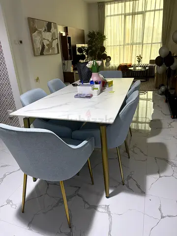 Modern marble-top dining table with 6 upholstered chairs - like new