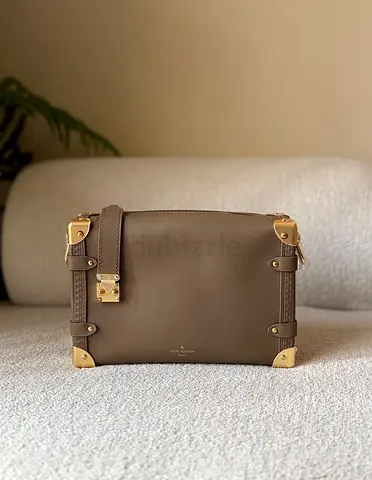 Trunk-style taupe leather crossbody bag with gold hardware