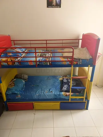 Children's colorful metal bunk bed with mattress and storage
