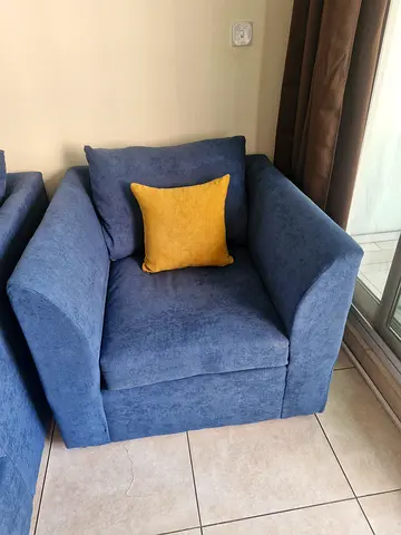 Comfortable blue fabric armchair with cushion