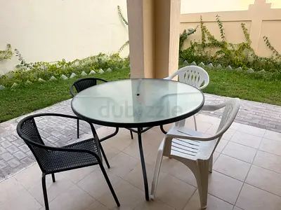 Urgent sale - Large (1.2m) 6 str Outdoor round glass dining table with 4 mixed chairs & Umbrella snd