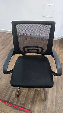 Used black mesh visitor office chair with armrests