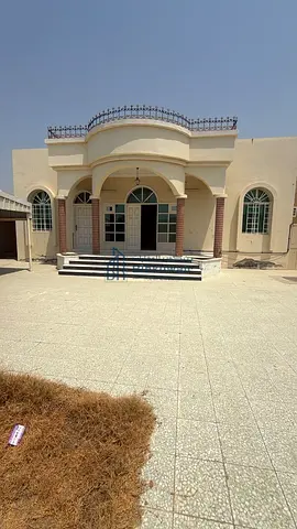 Traditional-style house for sale in Al Shahba, Sharjah. Area: 8,000 square feet. Divided into two separate units with two utility meters.
