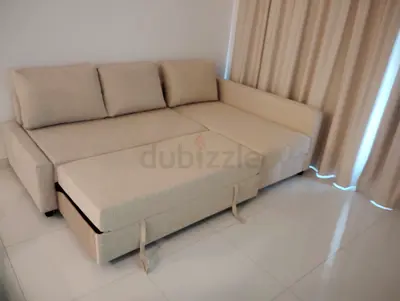 Beige L-shaped Sofa Bed with Storage - Good Condition