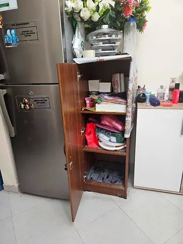 Small wooden storage cabinet with shelves and lockable door