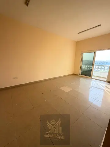 Two-bedroom apartment with a living room available for rent in Muwaileh, featuring an open view, balcony, and two bathrooms. The apartment offers a sp