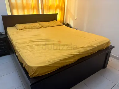 Solid dark wood double bed frame with headboard and storage