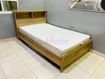 Single wooden bed frame with headboard storage and mattress