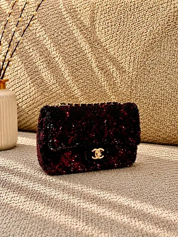 Small black sequined shoulder bag with gold CC clasp