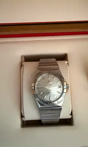 Omega Constellation stainless steel men's watch - silver dial with gold accents.