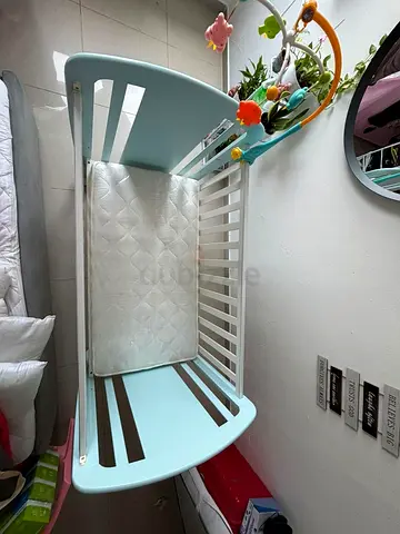 Light blue baby crib with mattress - good condition