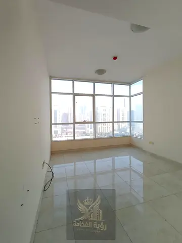 For annual rent in Al Taawun two bedroom apartment with living room balcony and open view with free parking two master bedrooms living room balcony wi