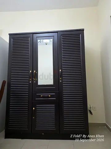 Dark wood 3-door wardrobe with mirror and drawers