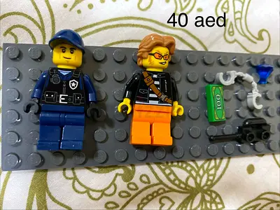 Two LEGO minifigures with accessories - police and civilian (used)
