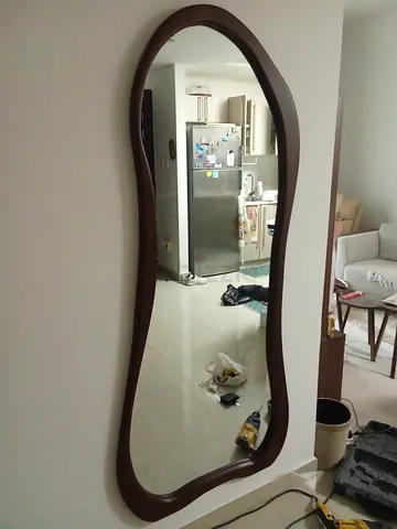 Full-length curvy wooden framed wall mirror - dark brown