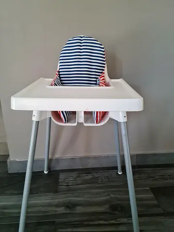 IKEA high chair with removable tray and striped cushion