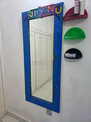 Full-length wall mirror with blue LEGO-style frame