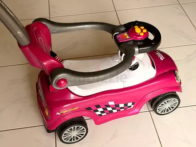 Pink ride-on push car with parental handle — good condition