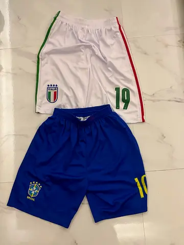 Two football shorts — Italy #19 and Brazil #10, used