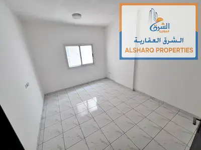A one-bedroom and living room unit in Al Rashidiya 2, featuring a spacious layout. An unpaved parking area is available next to the property. It boast