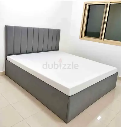 Grey Upholstered King Bed with Padded Headboard and Storage Base