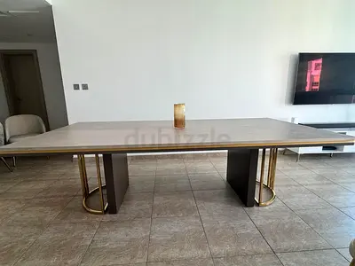 Large modern dining table with gold-accented legs - excellent condition