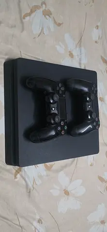 PlayStation 4 Slim with 2 DualShock Controllers - perfectly Working Condition