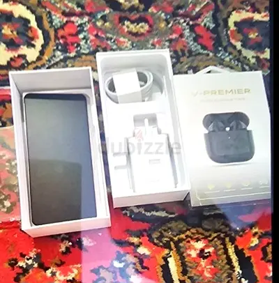 Used smartphone with charger and wireless earbuds (boxed) - good condition