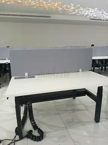 White office desk with grey privacy panel and cable spine - used