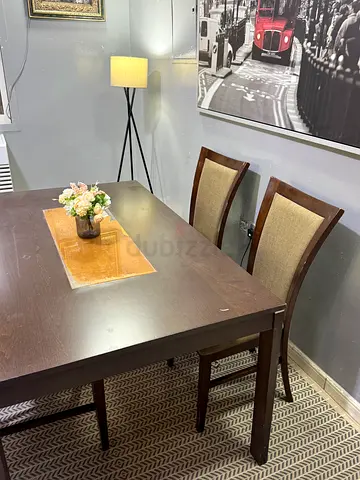 Dark wood rectangular dining table with 4 chairs