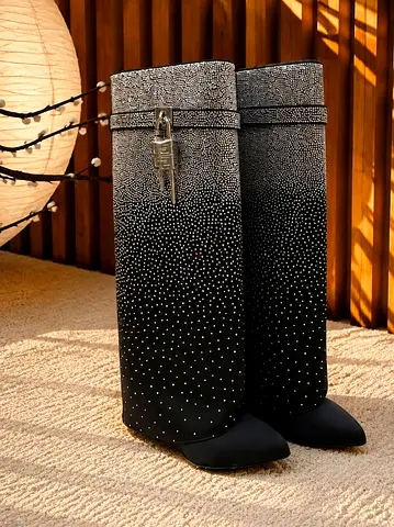 Black knee-high crystal-studded boots — size not specified