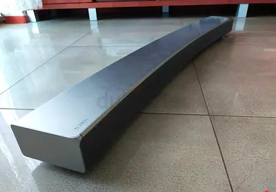 Curved soundbar speaker - sleek silver unit in good condition