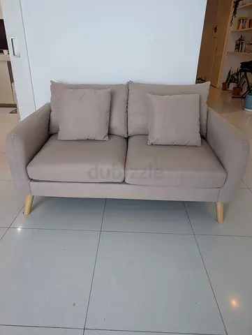 Home Center Compact 2-Seater Beige Fabric Sofa with Wooden Legs