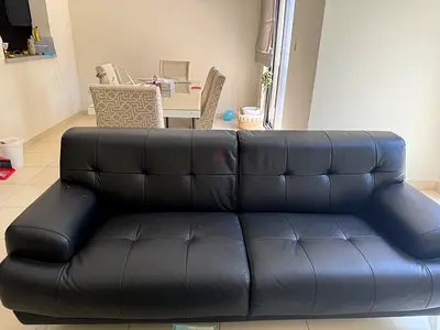 Black faux leather 3-seater sofa in good condition