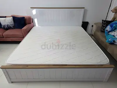 White wooden King bed frame with medium firm mattress - good condition