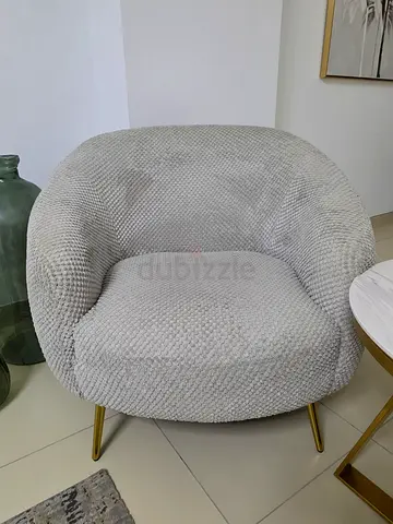 Light grey textured accent armchair with gold legs