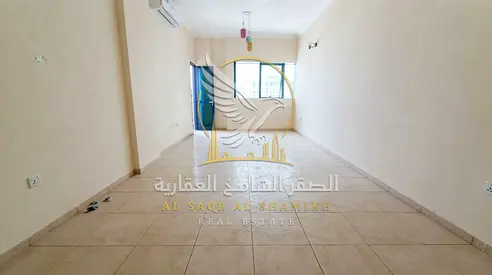 Two bedroom apartment with a living room in Al Majara Sharjah features a spacious layout a balcony and central air conditioning