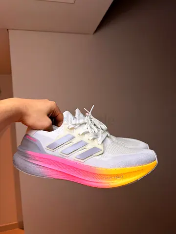 White adidas running shoes with gradient pink-yellow midsole — lightly used