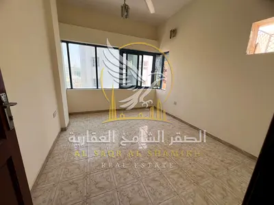 Two bedroom apartment with a living room for rent in Al Butina Sharjah spacious layout split AC and a quiet building