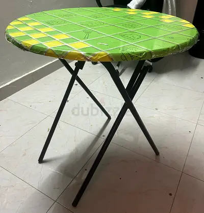 Foldable round metal bistro table with green top - good condition