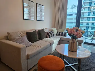 Light beige L-shaped fabric sofa with cushions