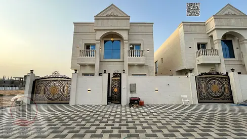 Villa for sale in Al Helio, Ajman, featuring 5 master bedrooms, a majlis, a living room, and a maid's room. Freehold ownership available for all natio