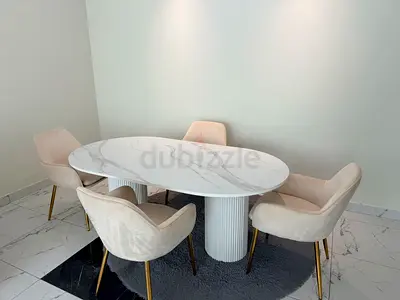 Oval white marble-effect dining table with 4 beige velvet chairs