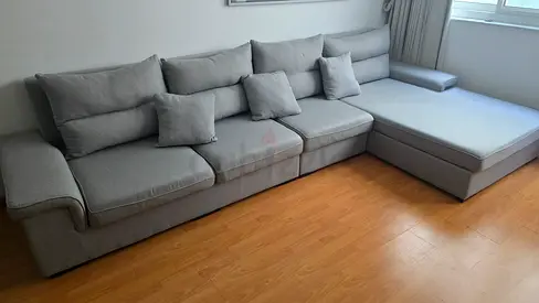 Light grey L-shaped fabric sofa with chaise, good condition