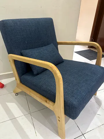 Single armchair with wooden frame and blue upholstery