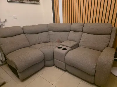 Grey 6-seater L-shaped reclining sofa with center console and cup holders