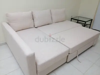Light beige L-shaped sofa bed with storage, good condition