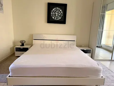 White modern queen bed with matching bedside tables