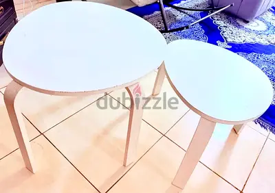 Set of 2 round white nesting side tables - light wood legs