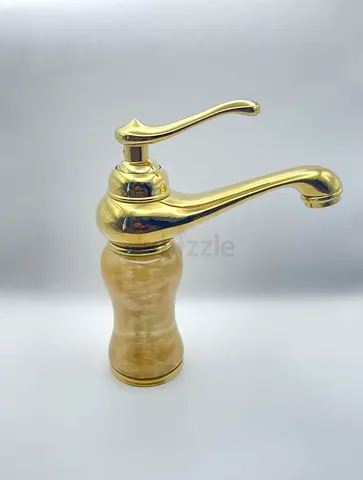 Gold single-handle basin faucet with marble-look base